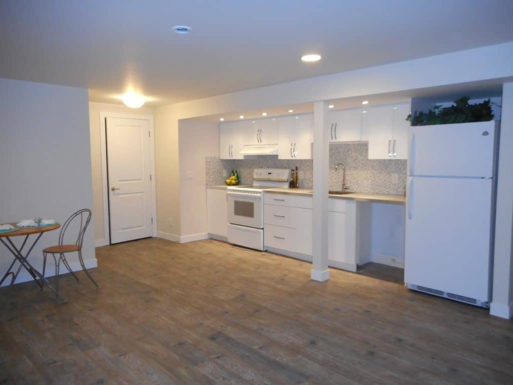 New cabinetry, backsplash, countertop, flooring and lighting make this space bright and light.