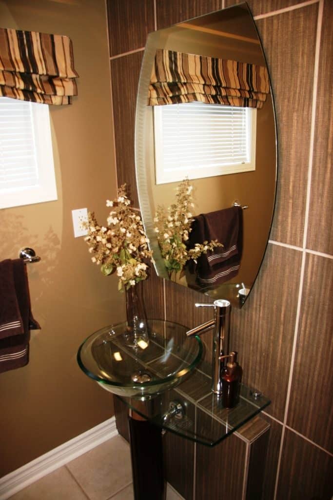 Contemporary glass sink creates a wow factor in this powder room