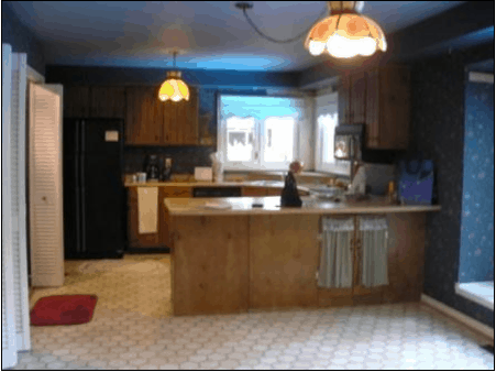 Dark dreary kitchen had wallpaper and dated flooring and lighting.  House was crying out for a kitchen renovation.
