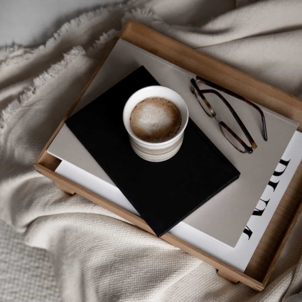 A cup of a drink placed on top of books