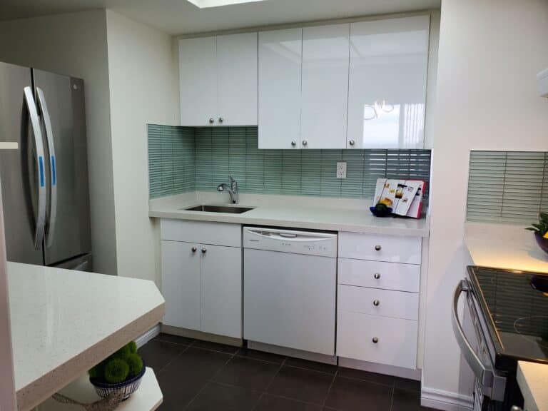 A kitchen with quartz countertop and stainless steel fridge