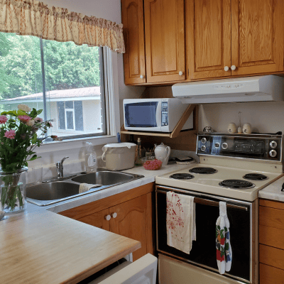 Dated kitchen with view of window before