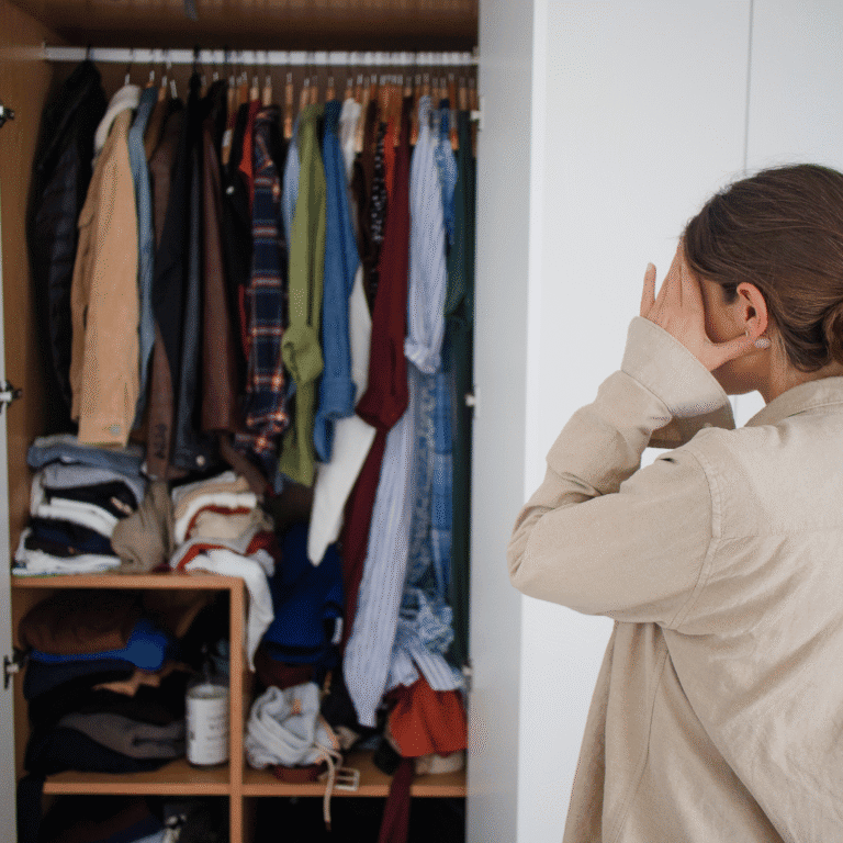 Woman looking at cluttered closet