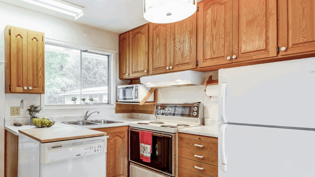 Dated kitchen with pine cabinets and white appliances