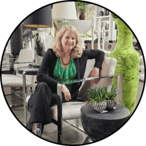 Clarissa Stevens-Guille, Interior Decorator and Realtor in Mississauga and Oakville, sitting in a chair surrounded by elegant, timeless décor