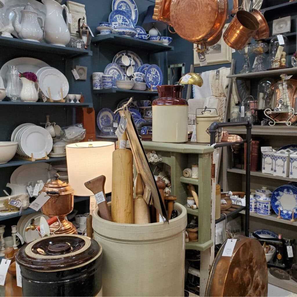 Collection of housewares and rolling pins for sale in an antique store