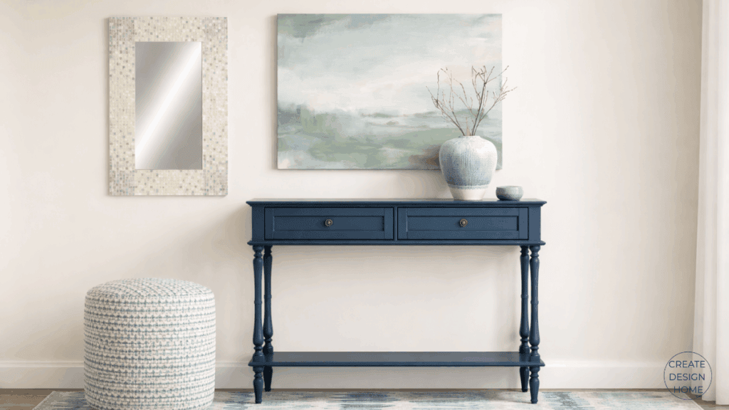 Coastal entryway featuring light wood furniture, woven textures, soft blue accents, and shell-inspired mirrors