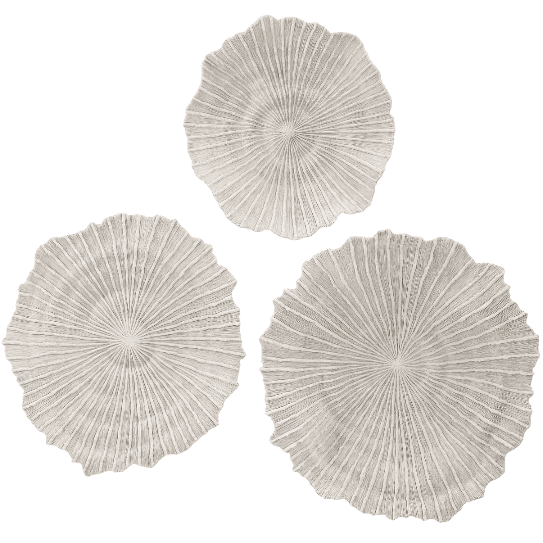 Textured coral-inspired wall discs in soft ivory and sand.