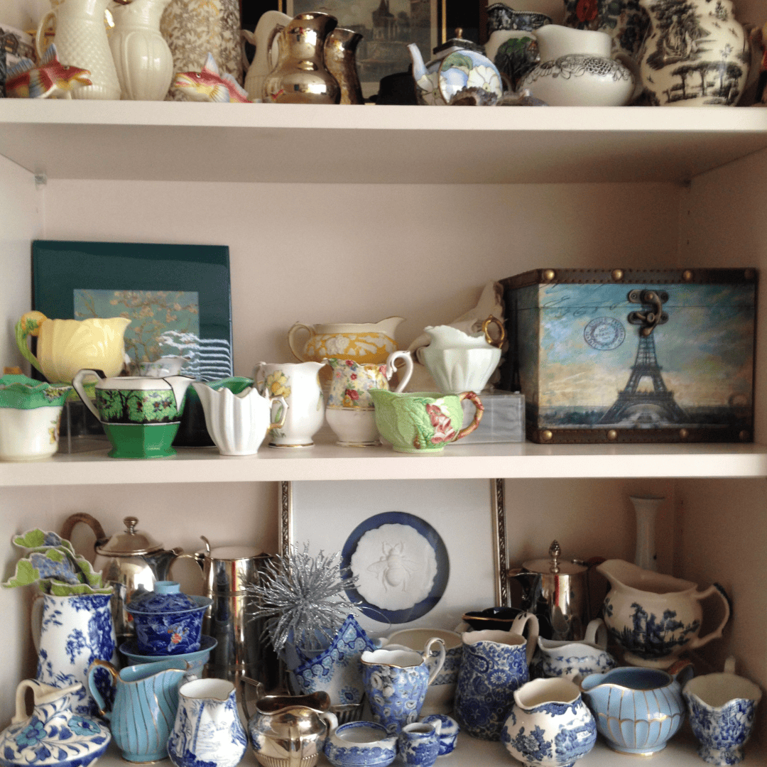 3 shelves of creamers in a bookshelf