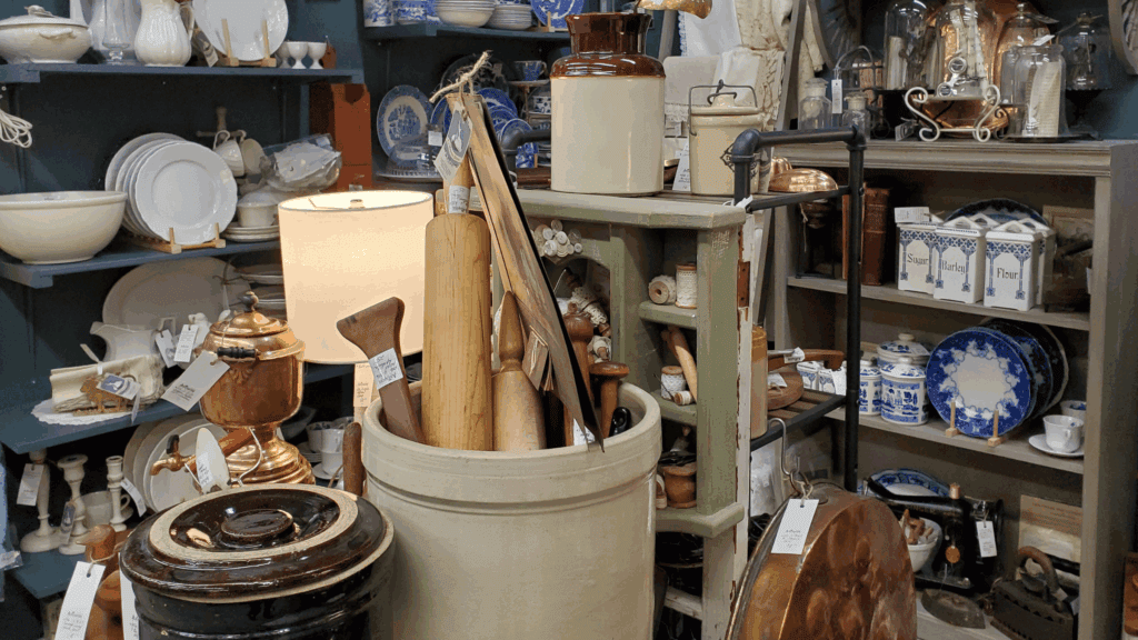Collection of housewares and rolling pins for sale in an antique store