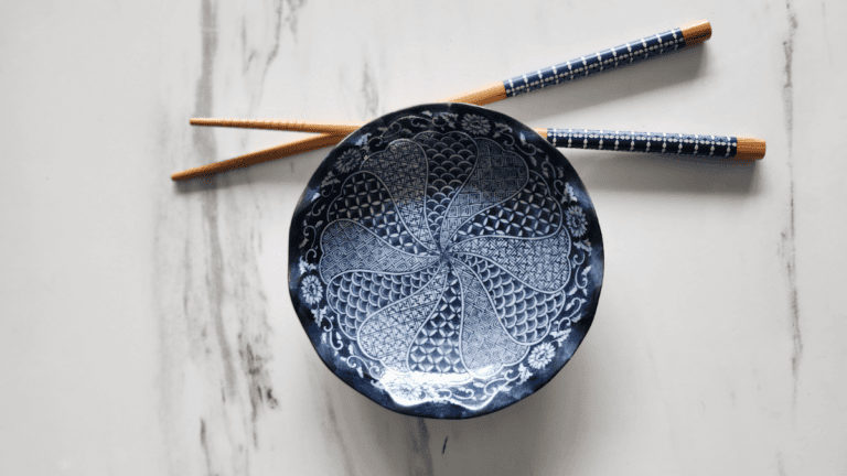 Blue patterned bowl and chopsticks reflecting Ma, the Japanese philosophy of intentional space and quiet simplicity.