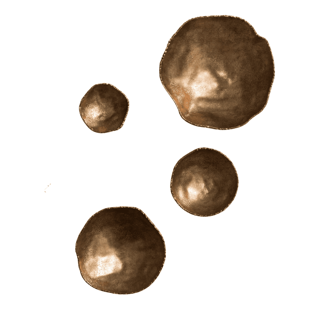 Layered brass wall sculptures add texture, depth, and visual interest