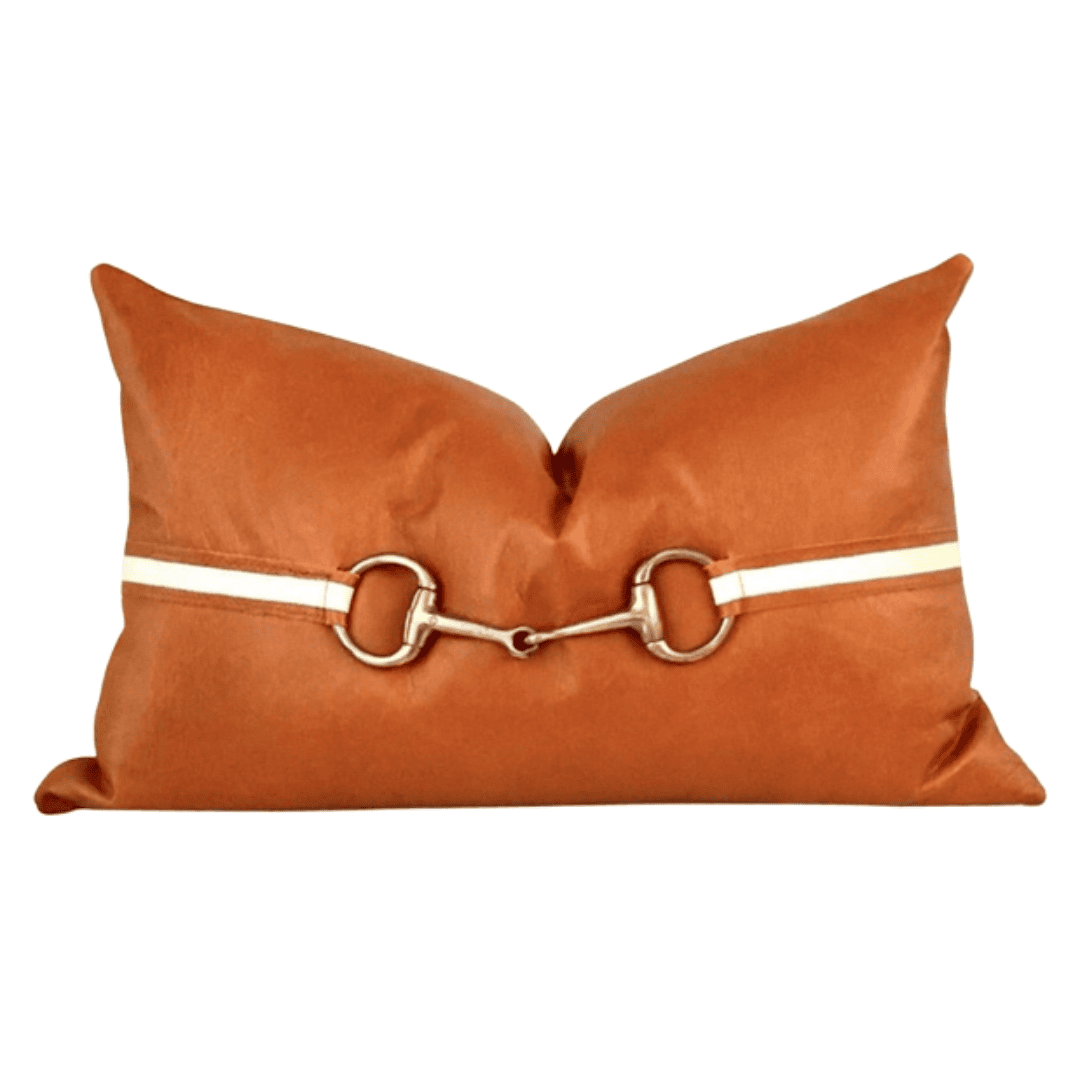 Tan leather pillow with brass horse bit detail