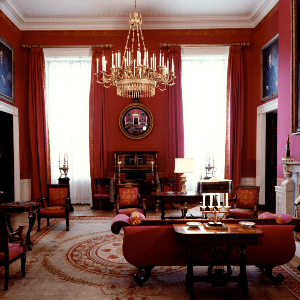 Red Room in the White House after Jacqueline Kennedy’s 1962 restoration, featuring crimson walls, gilded accents, and American Empire furnishings.