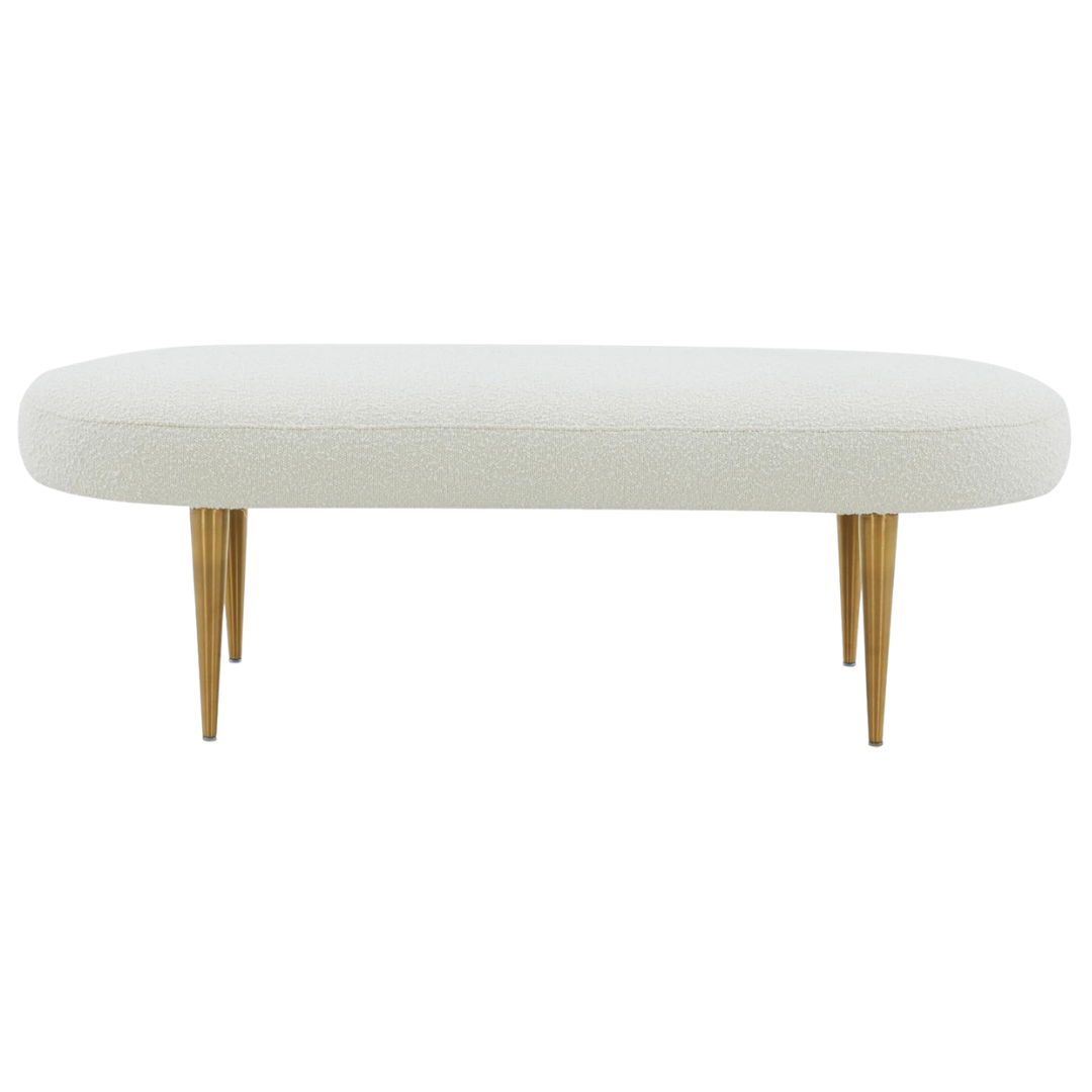 Upholstered cream bench with gold legs at foot of bed