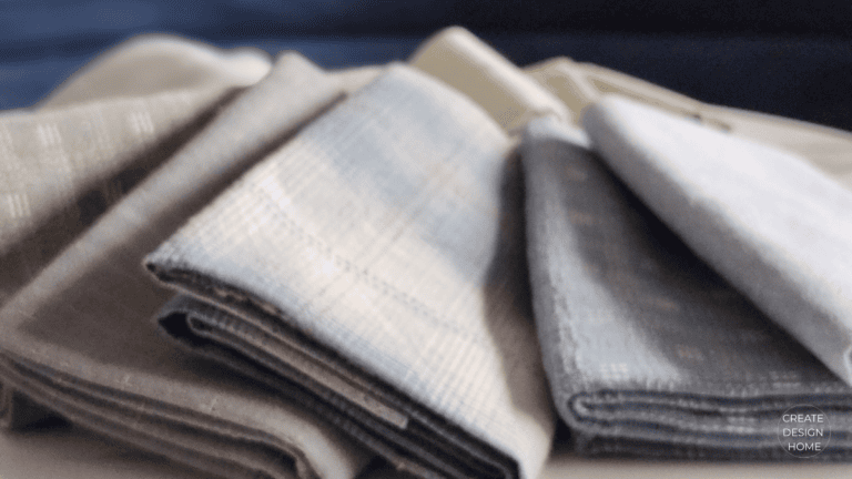Folded neutral linens representing Seiri, putting in order through calm simplicity and organization.