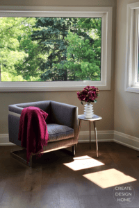 Quiet reading corner with chair and flowers reflecting Shibumi, effortless excellence and understated comfort.