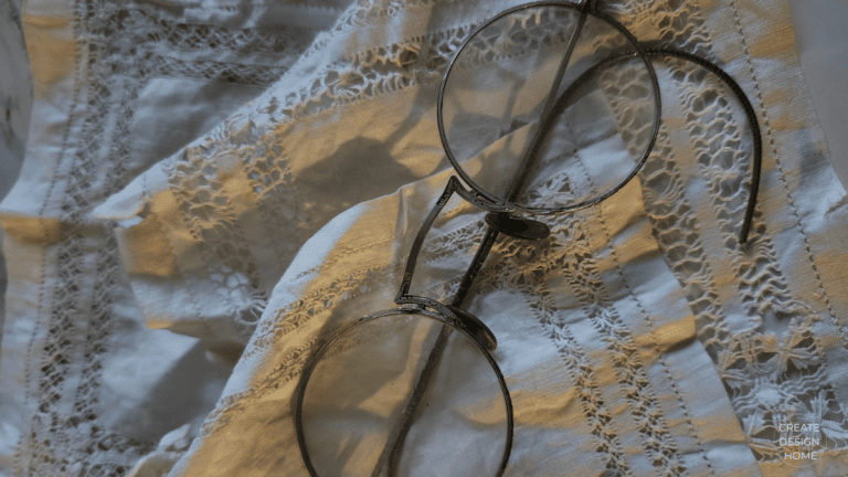 Eyeglasses resting on textured fabric representing Wabi-Sabi, beauty in imperfection and everyday living.