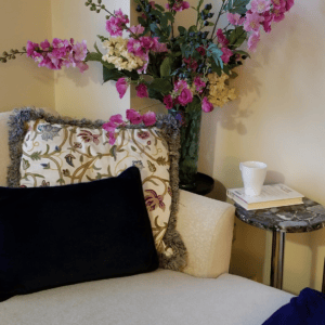 Cozy reading corner with books, coffee, and flowers for a book review series on organization and intentional living