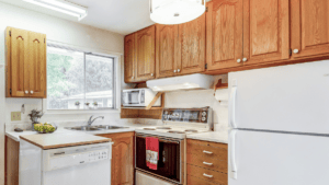 Older kitchen with oak cabinets staged to maximize buyer appeal