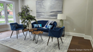 Professionally staged living room with blue chairs and neutral decor