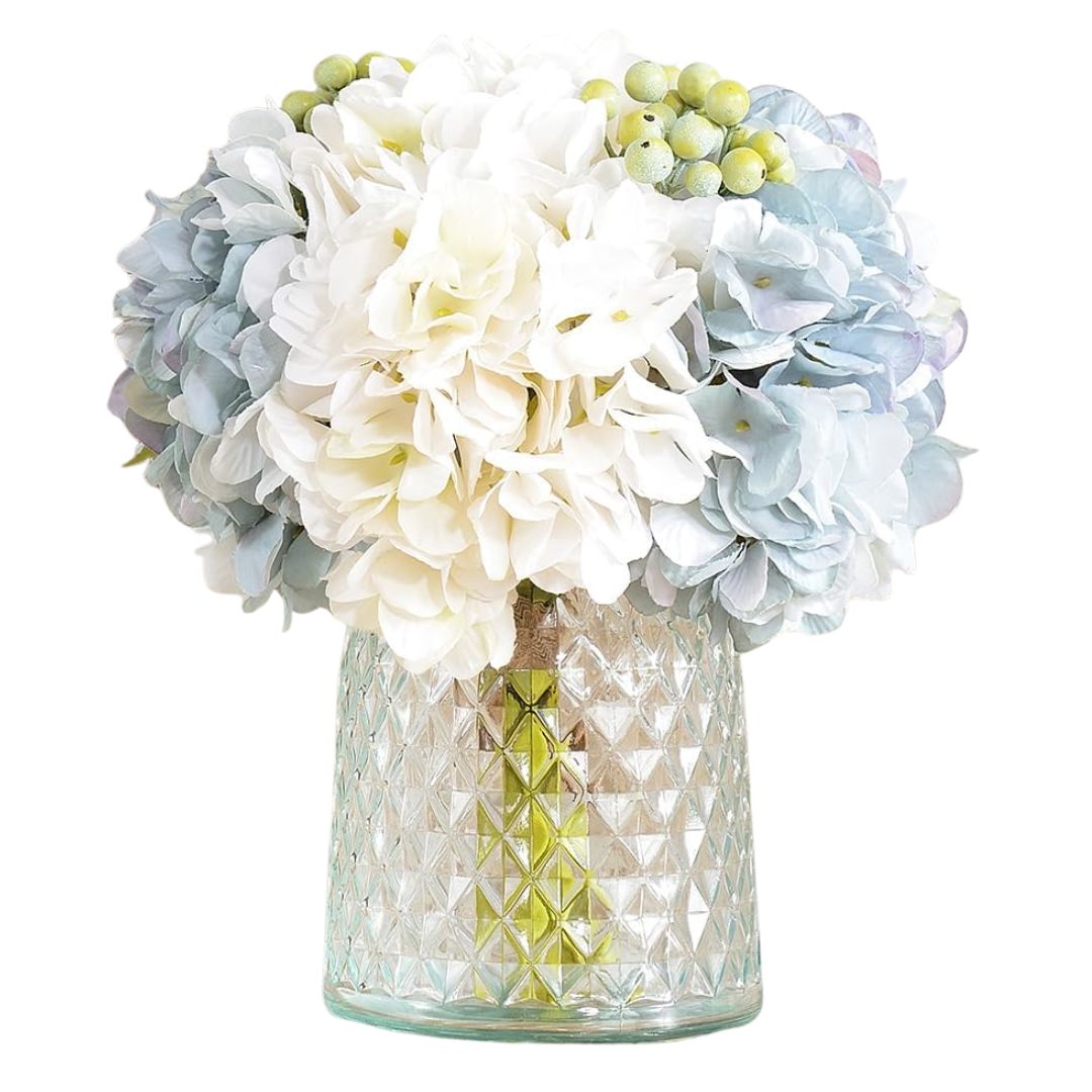 Faux white and pale blue hydrangeas in glass vase