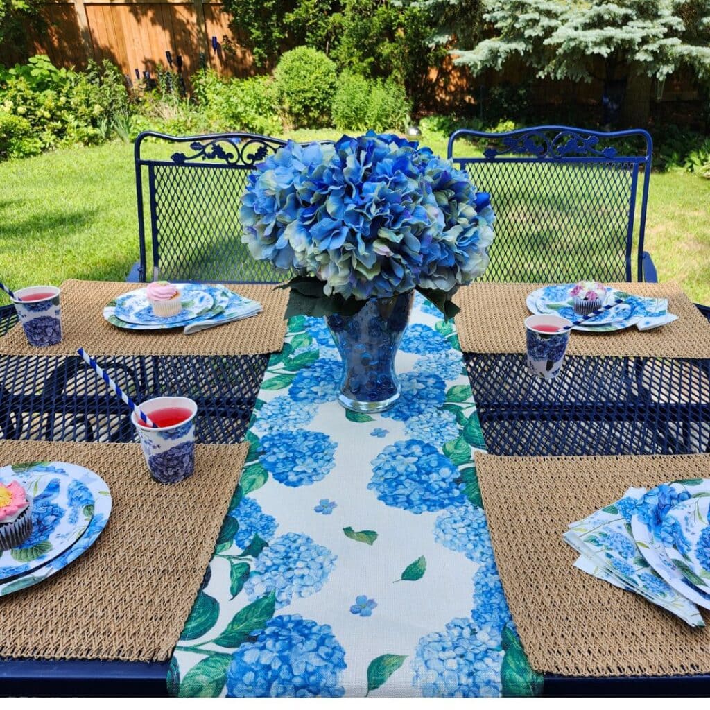 Blue hydrangea centrepiece on a hydrangea-inspired outdoor table