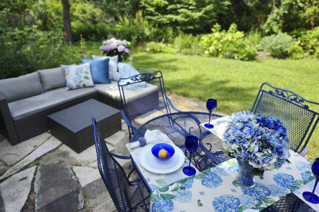 Hydrangea-inspired summer table and outdoor seating in a green garden