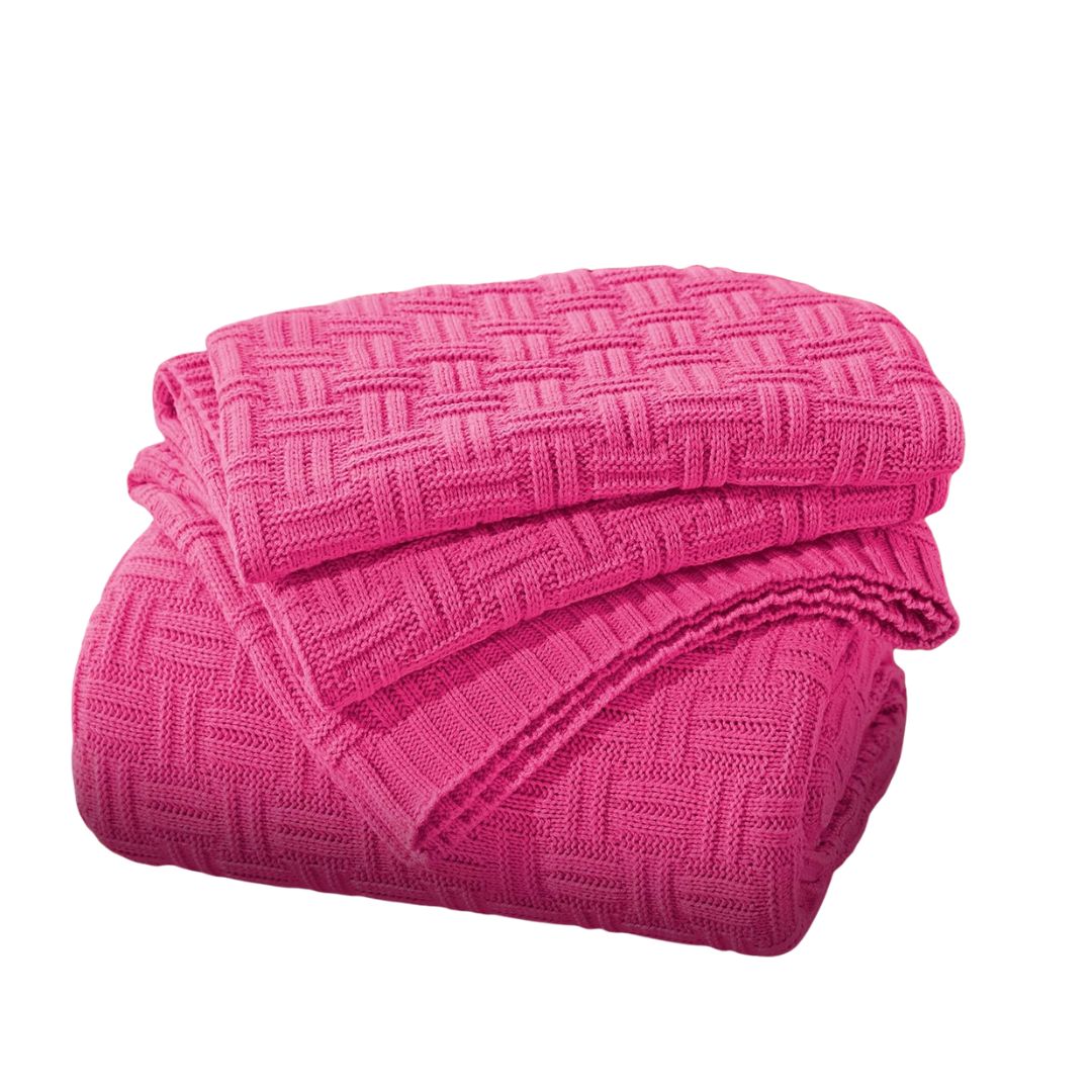 Pink textured throw blanket draped over outdoor patio furniture.