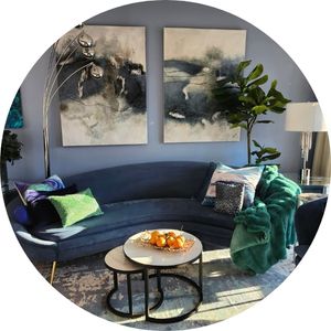 Elegant blue living room with contemporary furniture and artwork.