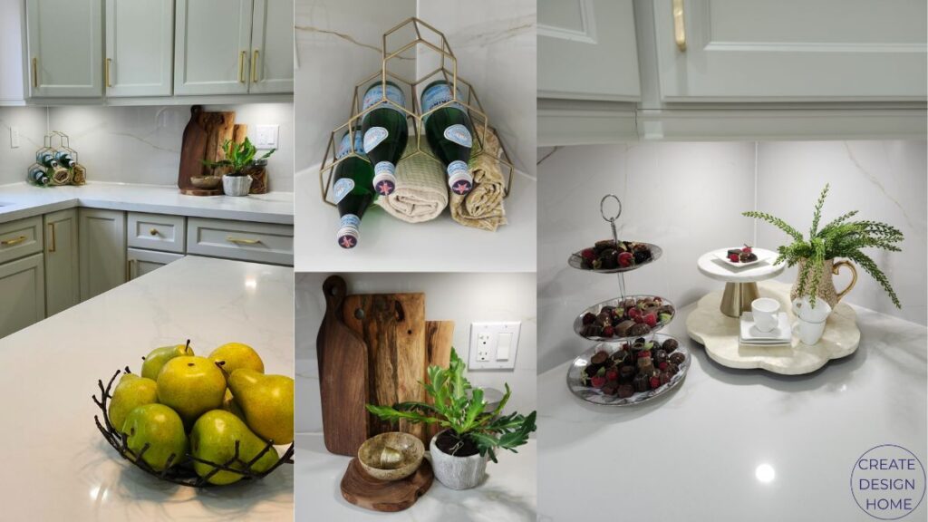 Styled kitchen countertop featuring cutting boards, fruit bowl, greenery, serving pieces and elegant countertop accessories.