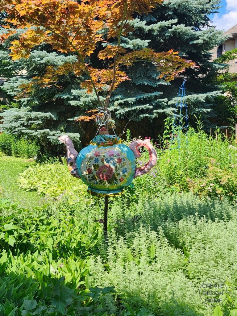 Large teapot-shaped balloon decorating the entrance to an English country garden tea party.