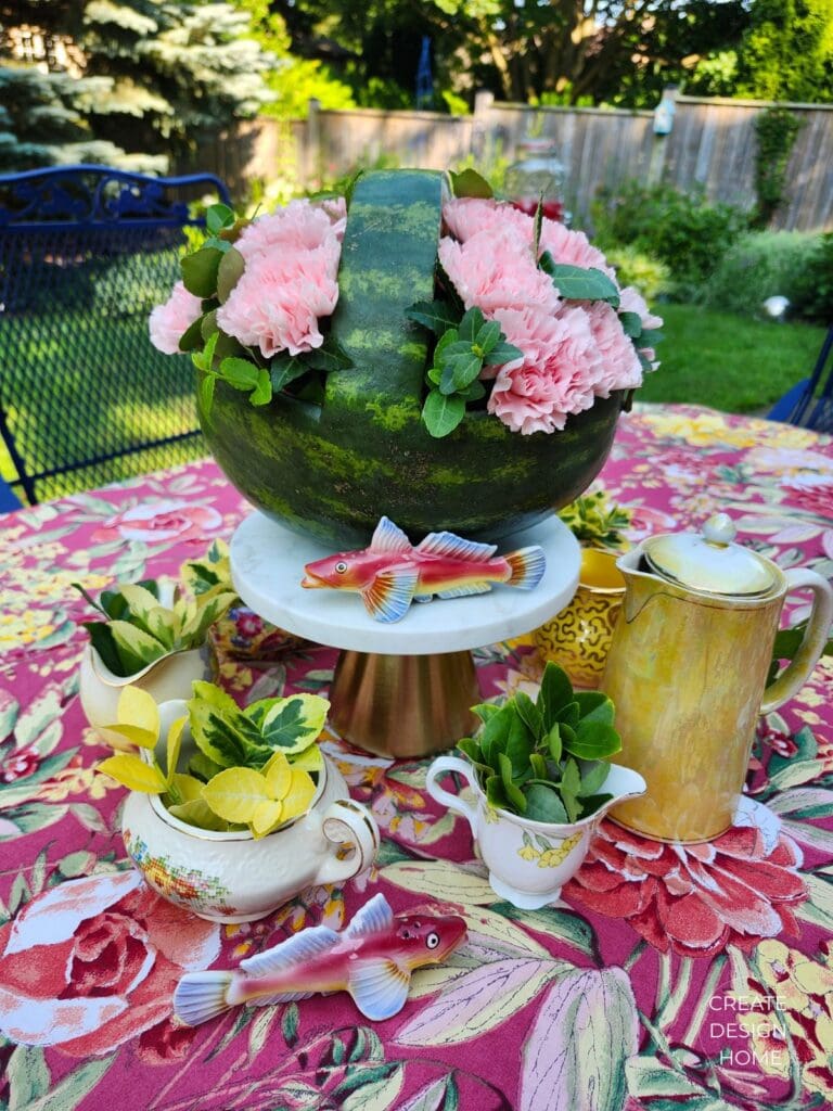 Vintage creamers and pink shark salt and pepper shakers styled on a floral garden tea party table