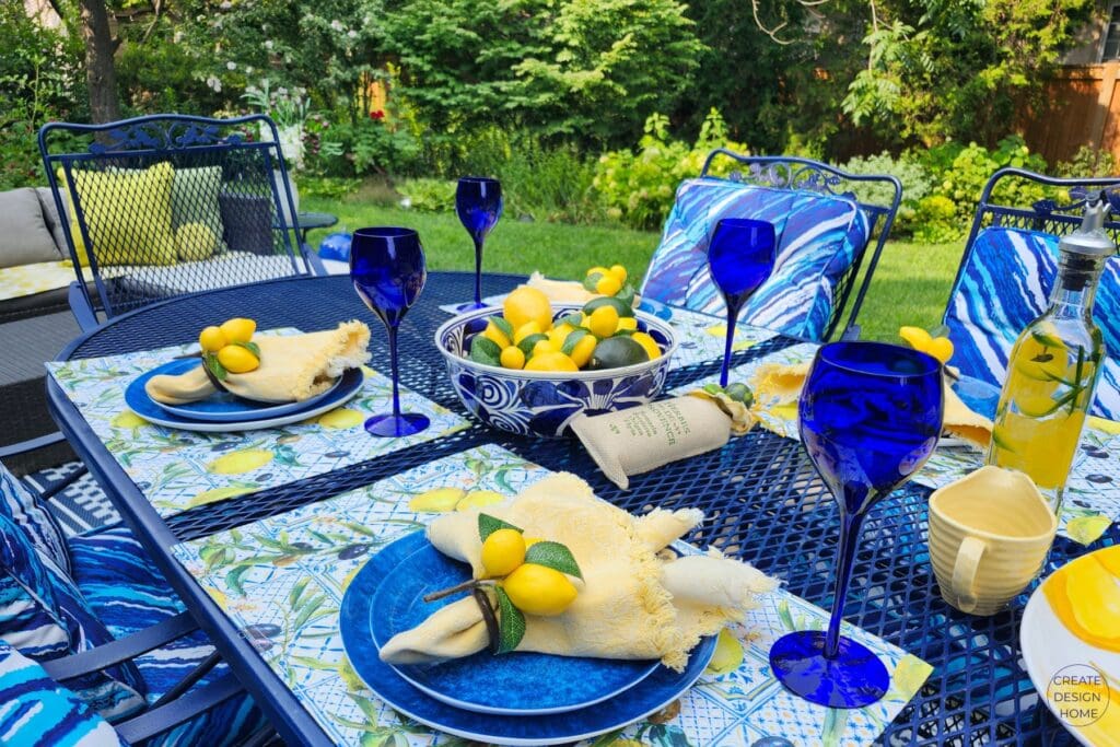 Decorating with lemons on a blue and yellow outdoor summer table