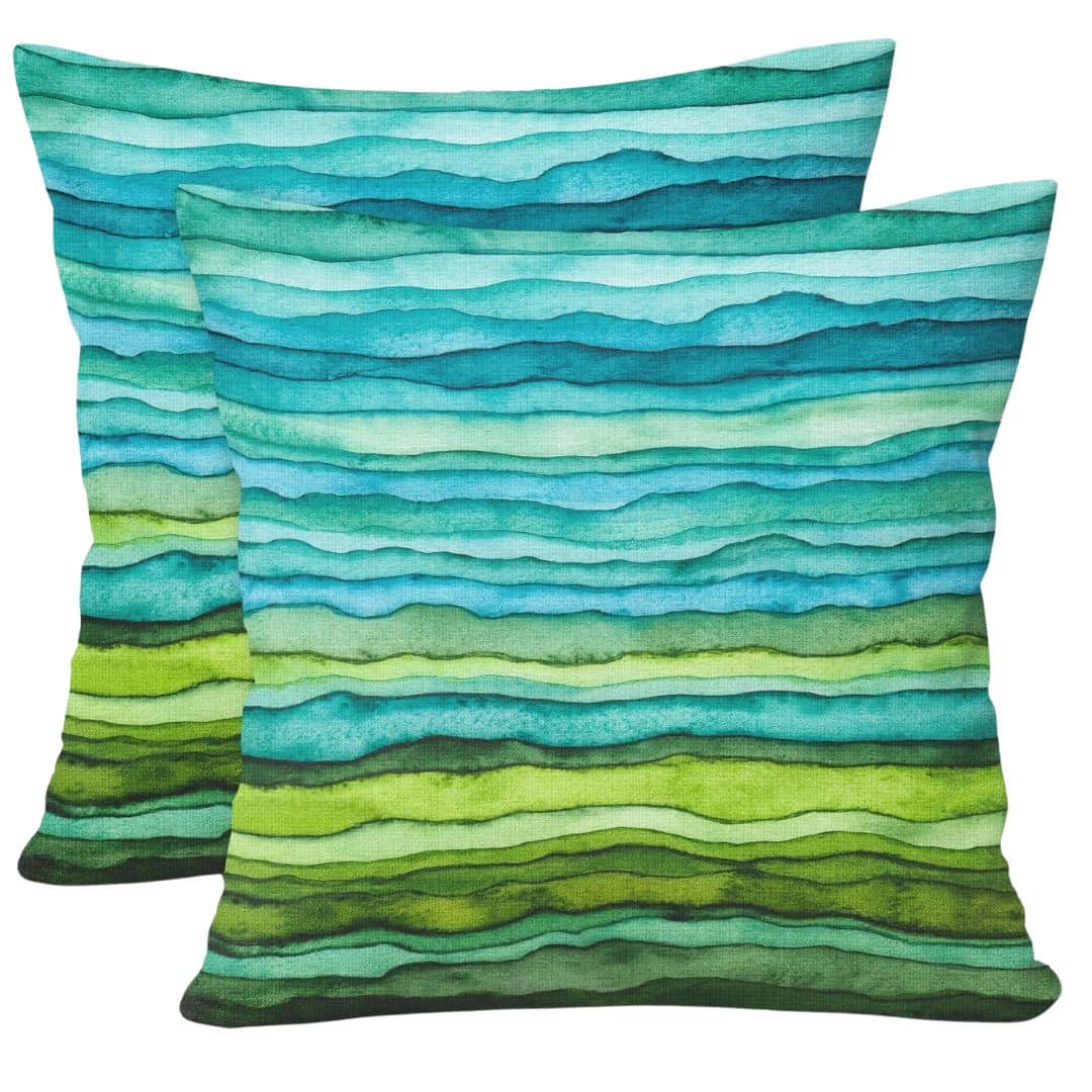Blue and green outdoor accent cushions with watercolor pattern