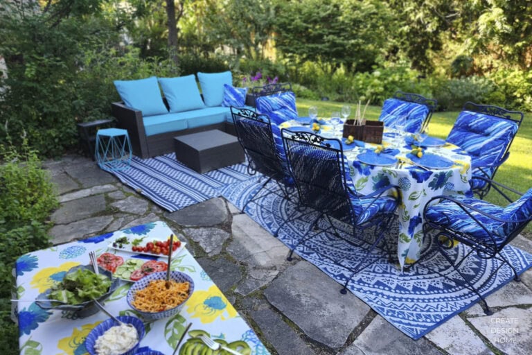 Colourful summer patio with turquoise seating, blue dining chairs and an outdoor table set for entertaining
