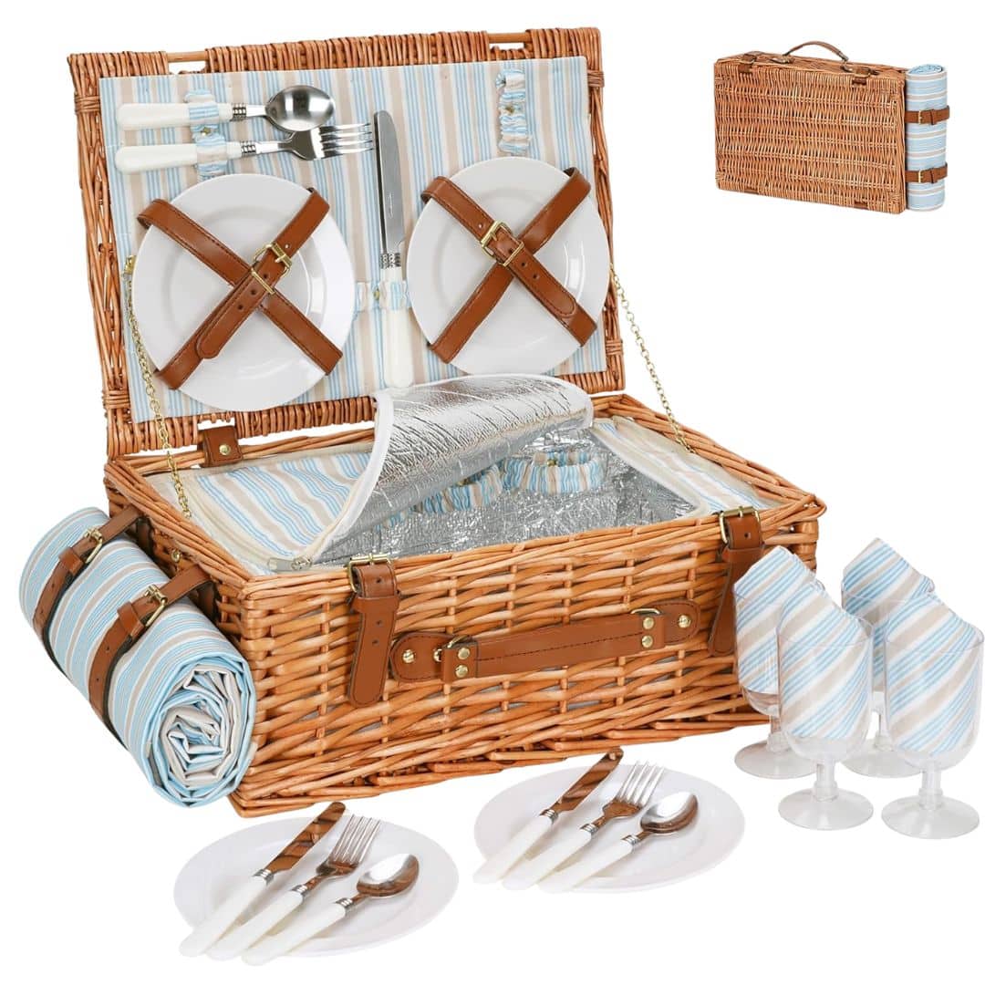 Traditional wicker picnic basket with plates, cutlery and glasses