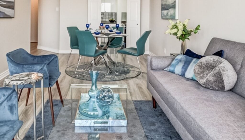 Professionally staged living and dining room in blue and neutral tones